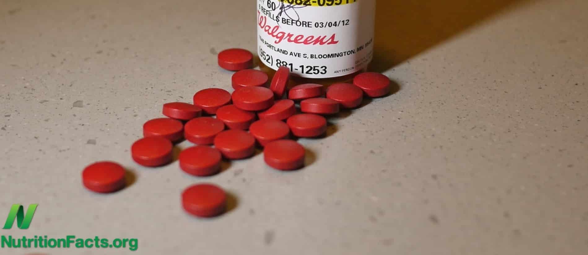iron supplements laying on a surface in front of the container