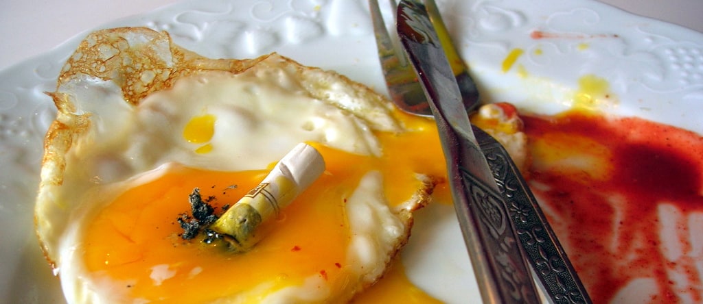 fried egg with a cigarette stump on top