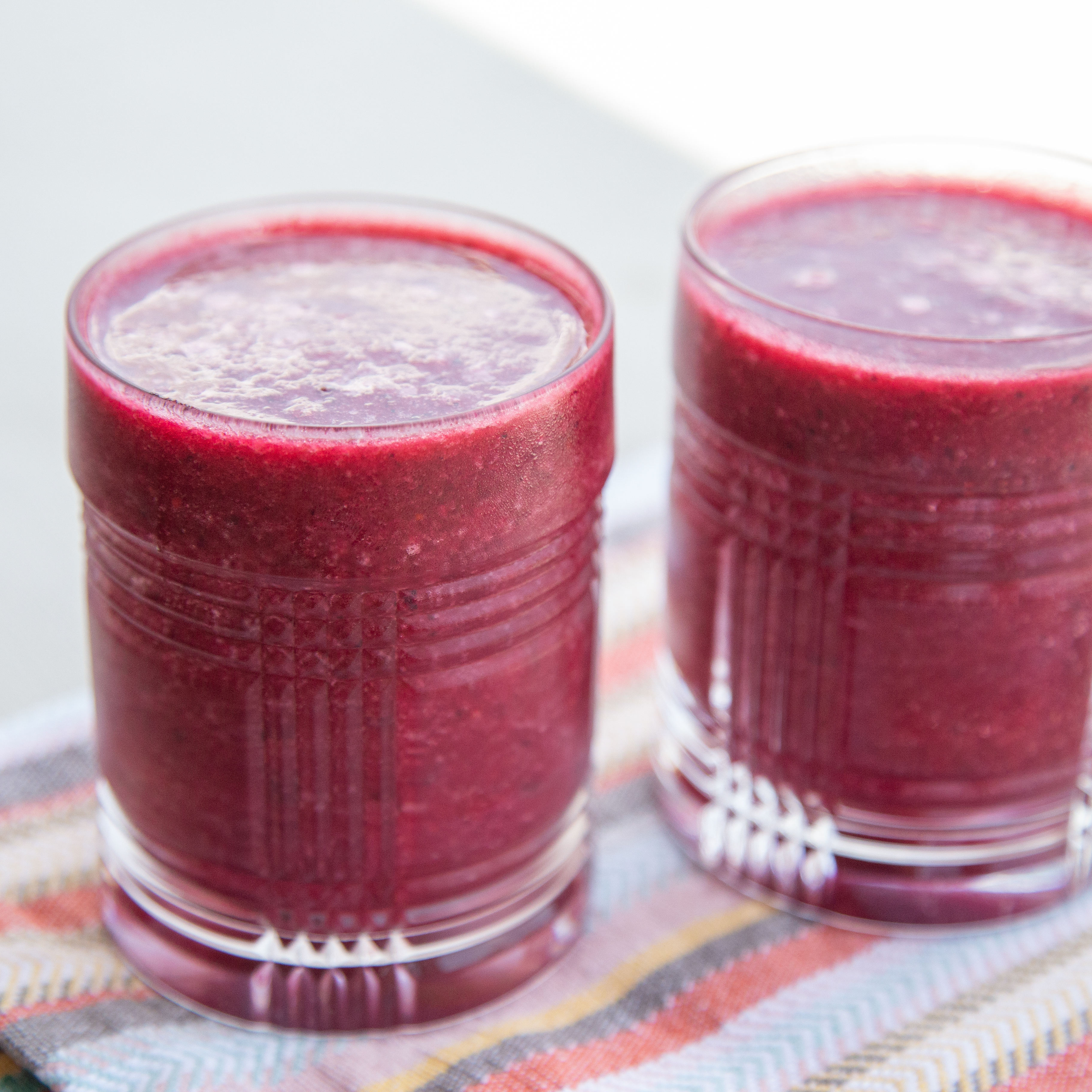 two glasses filled with watermelon smoothie